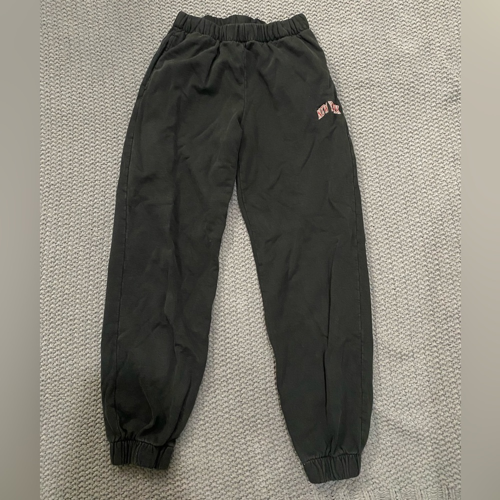 black brandy Melville sweatpants with “new york” on pant-leg. fits size small